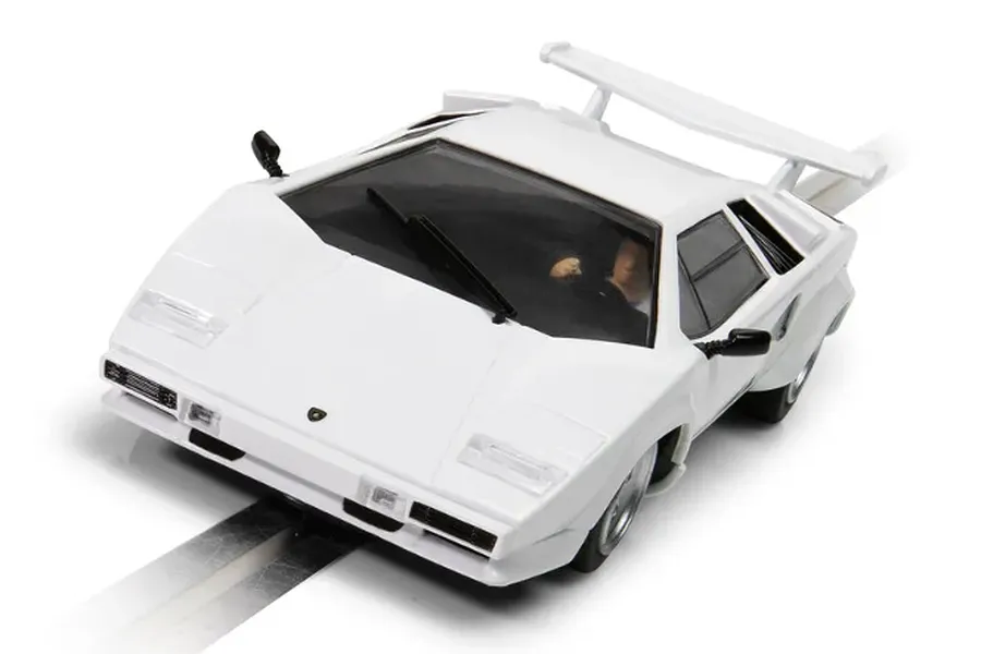 A white Scalextric 1/32 scale Lamborghini Countach slot car on a track section.