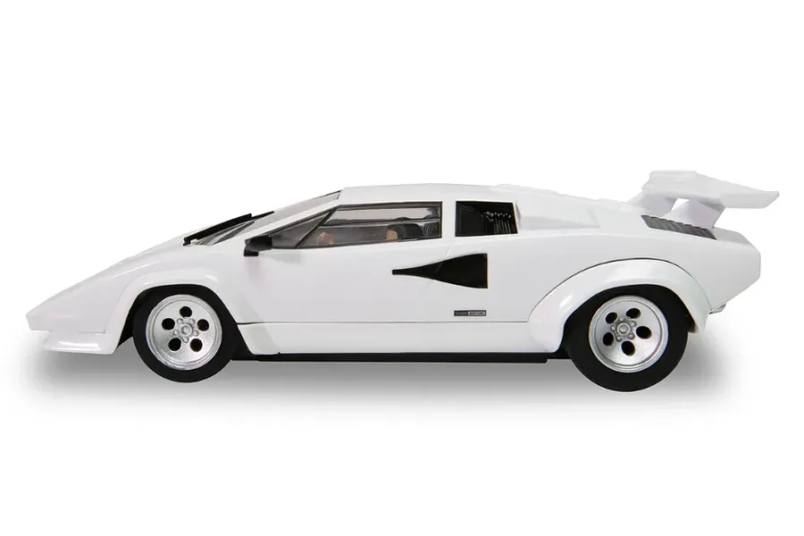 A side profile view of a white Scalextric 1/32 scale Lamborghini Countach slot car against a white background.