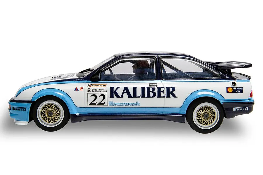 Side view of a 1/32 scale Scalextric Ford Sierra RS500 slot car in white, blue, and black livery with number 22 and Kaliber branding.
