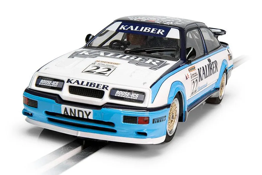 A 1/32 scale Scalextric Ford Sierra RS500 slot car in white and blue Kaliber livery, number 22, on a track.