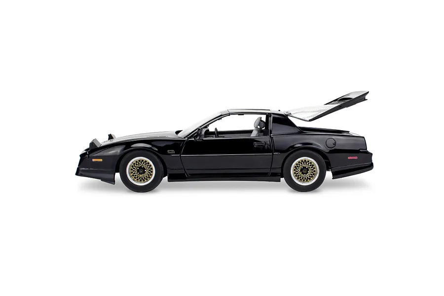 Side profile view of a black 1/16 scale model of a 1987 Pontiac Firebird GTA with the rear hatch open.