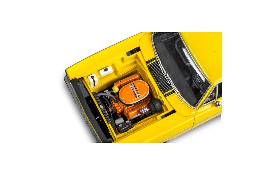 High-angle view of a yellow 1970 Plymouth Roadrunner model car with the hood open, revealing a detailed orange V8 engine.