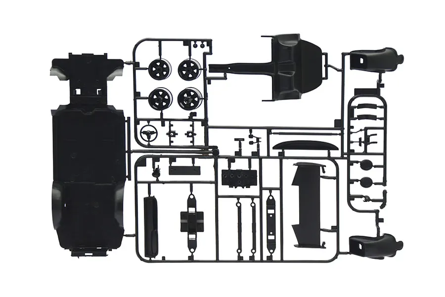 A black plastic model kit sprue containing various car parts for an Italeri 1/24 scale Porsche Carrera RSR Turbo model.