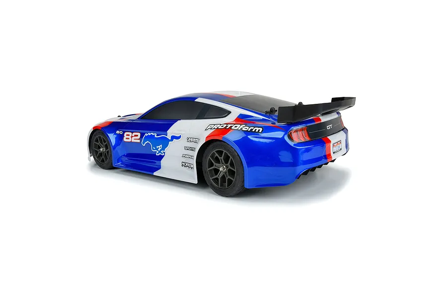 A pre-painted blue, white, and red Protoform 1/8 2021 Ford Mustang RC body shell viewed from the rear three-quarter angle on a white background.