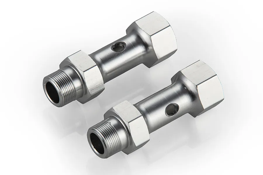 Two silver-coloured metal front double axle components for an RC vehicle, shown from a high-angle studio perspective.