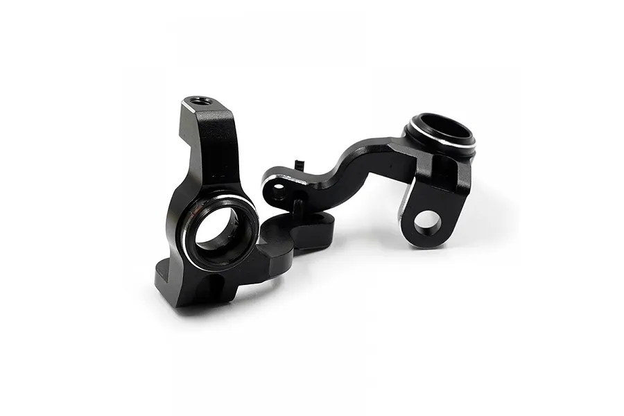 Two black anodized aluminium steering hubs for RC cars, shown from a side angle against a white background.