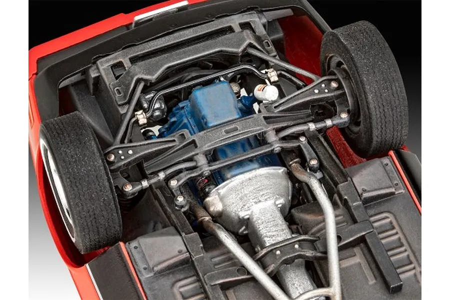 Close-up view of the detailed undercarriage and engine bay of a 1/24 scale Ford Mustang model kit.