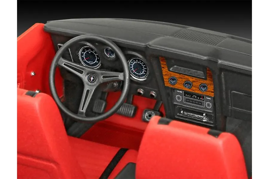 Interior view of a 1/24 scale model Ford Mustang showing the red seats, black dashboard, steering wheel, and wood-grain center console detail.