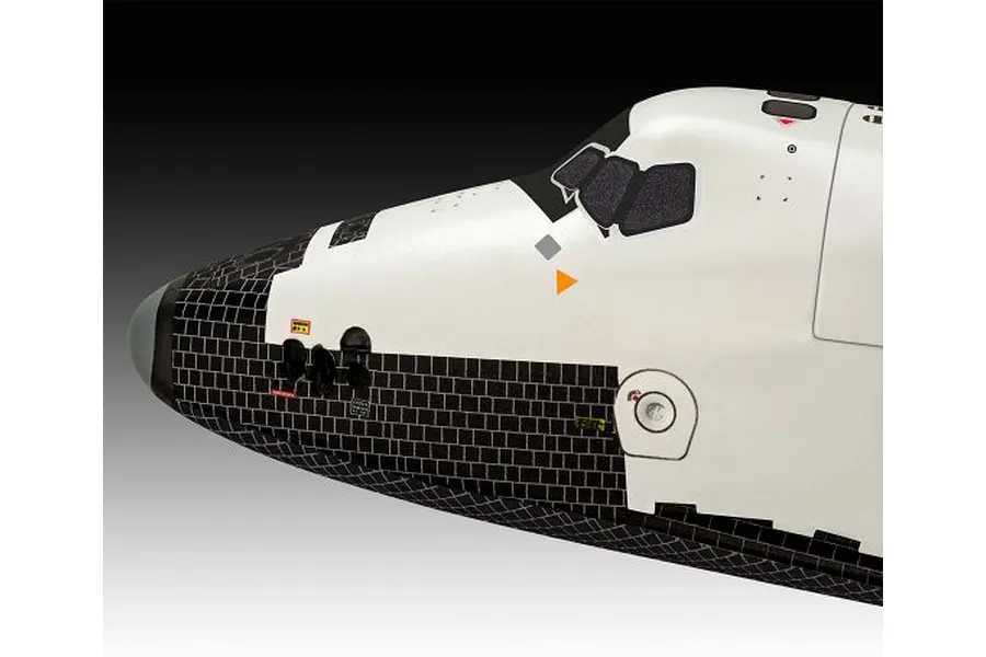Close-up of the nose section of a Moonraker space shuttle plastic model kit, showing white and black thermal tile detailing.