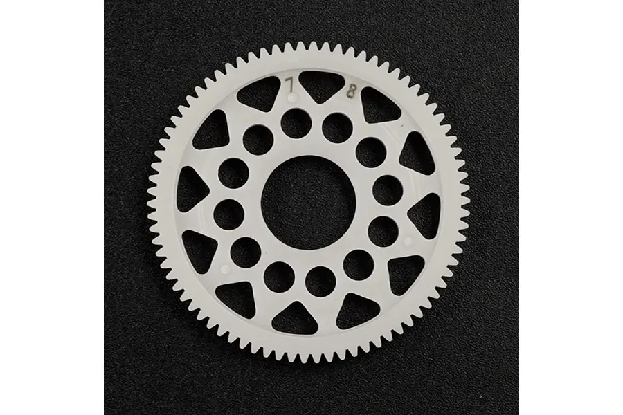 A white Delrin 78T 64dp spur gear for RC cars, featuring a lightweight design with circular and triangular cutouts, set against a black textured background.