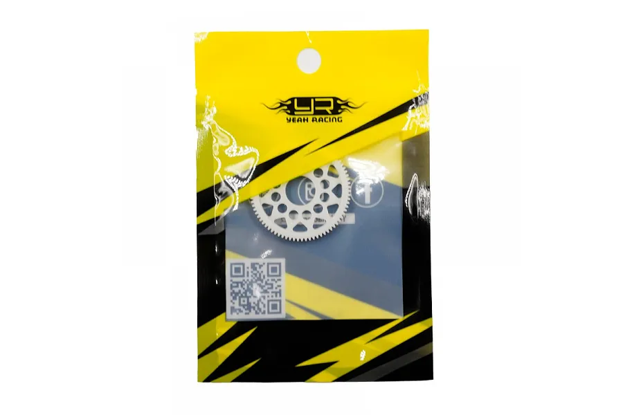 A white Delrin spur gear inside a yellow and black Yeah Racing branded plastic retail bag.