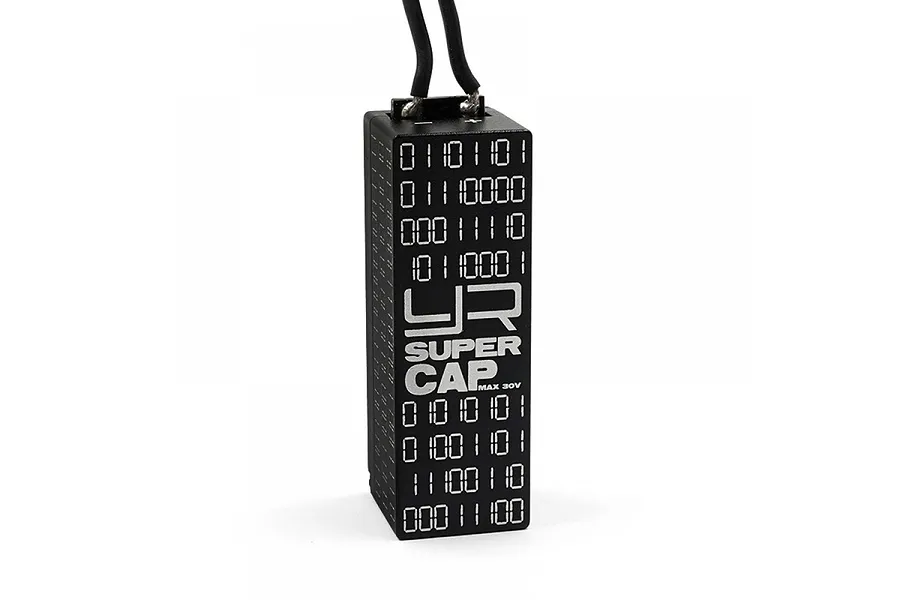 A black Yeah Racing aluminium super capacitor with binary code patterns and the YR logo printed on the side, isolated on a white background.