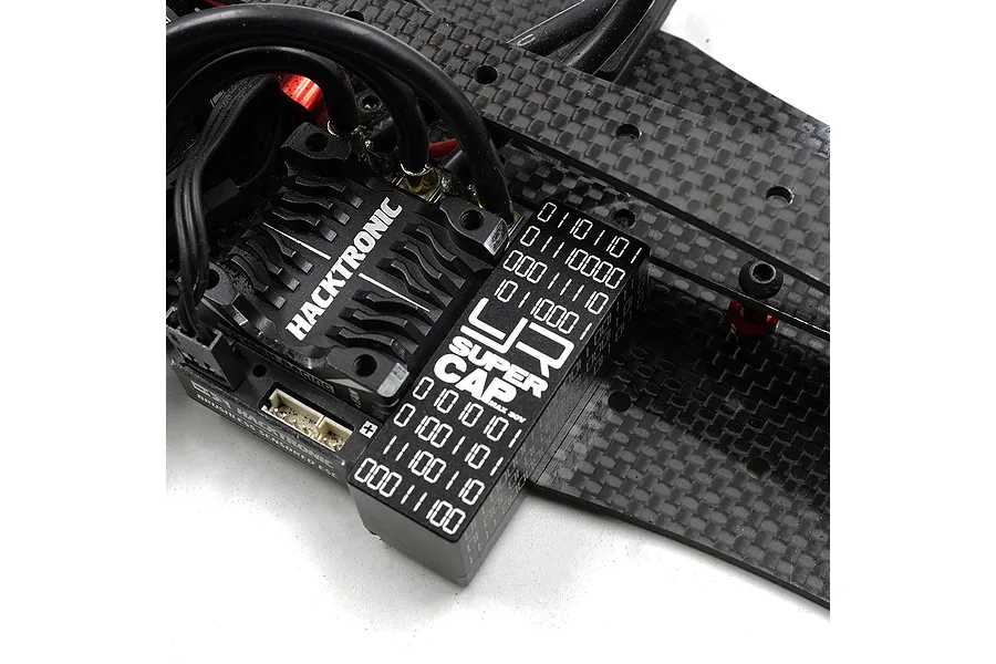 Yeah Racing Super Cap mounted next to a Hacktronic ESC on a carbon fiber RC chassis.