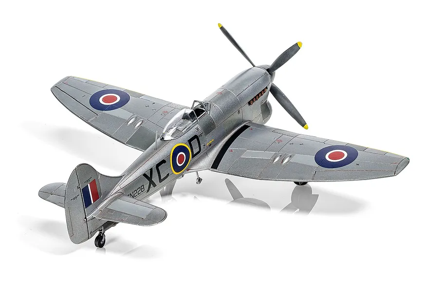 A high-angle studio shot of a 1/72 scale plastic model of a Hawker Tempest Mk.V fighter aircraft, painted in silver with RAF markings.