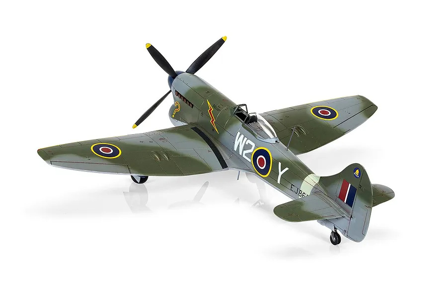 A completed 1/72 scale plastic model of a Hawker Tempest Mk.V fighter plane, painted in olive green and grey camouflage with RAF markings.