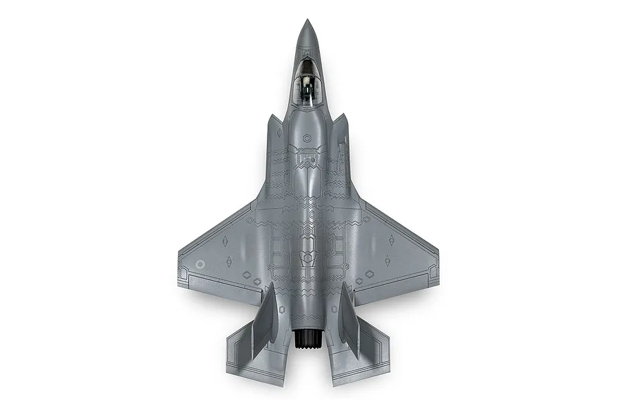 Top-down view of an assembled grey plastic model of a Lockheed Martin F-35B Lightning II fighter jet.