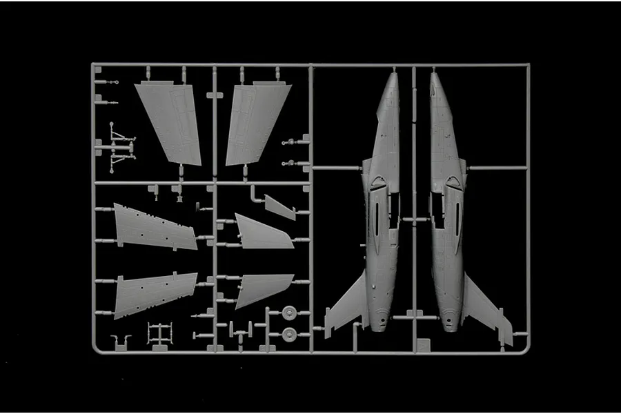 A grey plastic sprue containing parts for an AMX Ghibli model aircraft, including fuselage halves and wing sections, set against a black background.