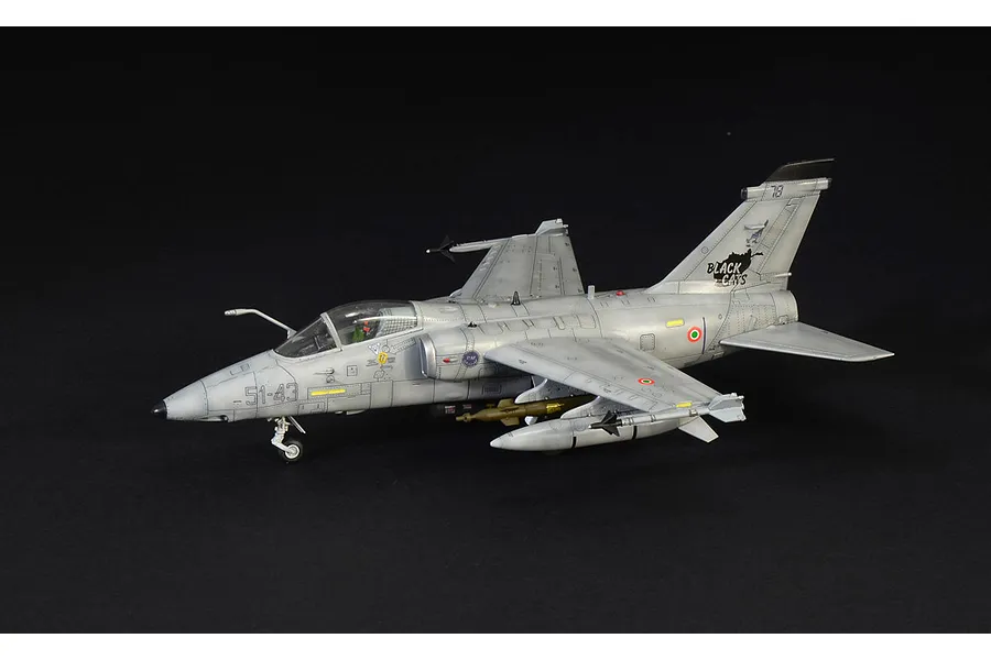 A side-view of a completed Italeri 1/72 scale AMX Ghibli model aircraft, painted in grey with Black Cats squadron markings on a black background.