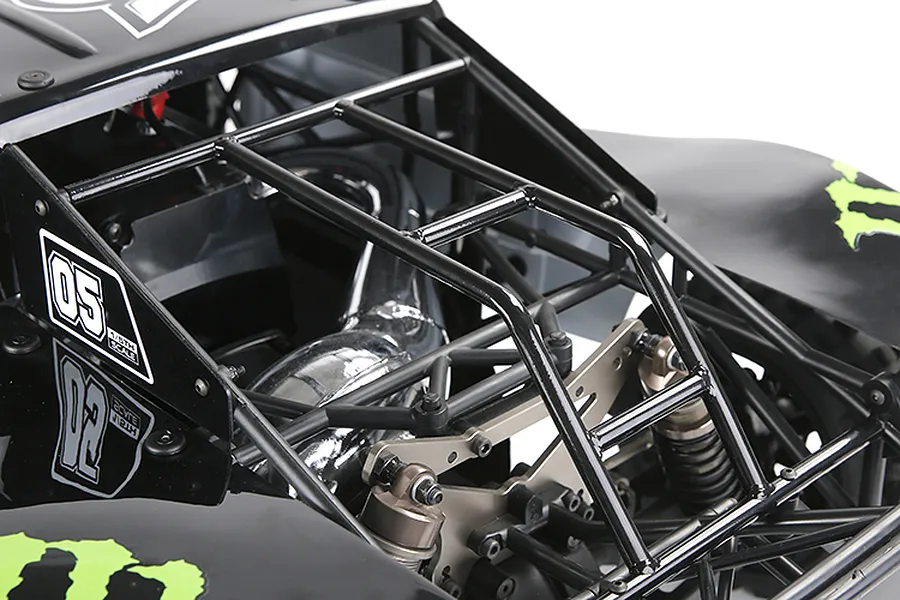 Close-up of a black Rovan 1/5 scale short course RC truck body shell and roll cage, showing internal components like the exhaust pipe and suspension.