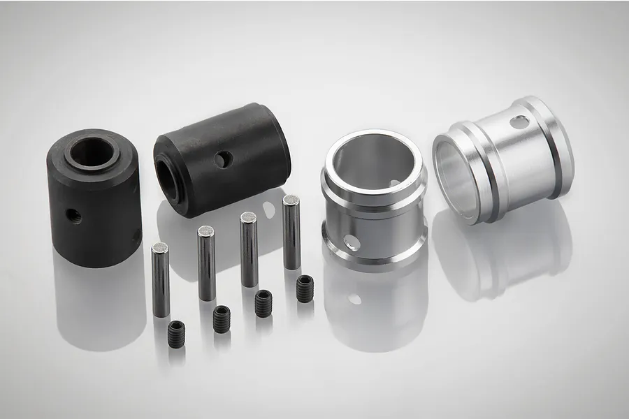 Rovan RC drivetrain output bushing kit including black and silver metal bushings, pins, and grub screws on a white background.