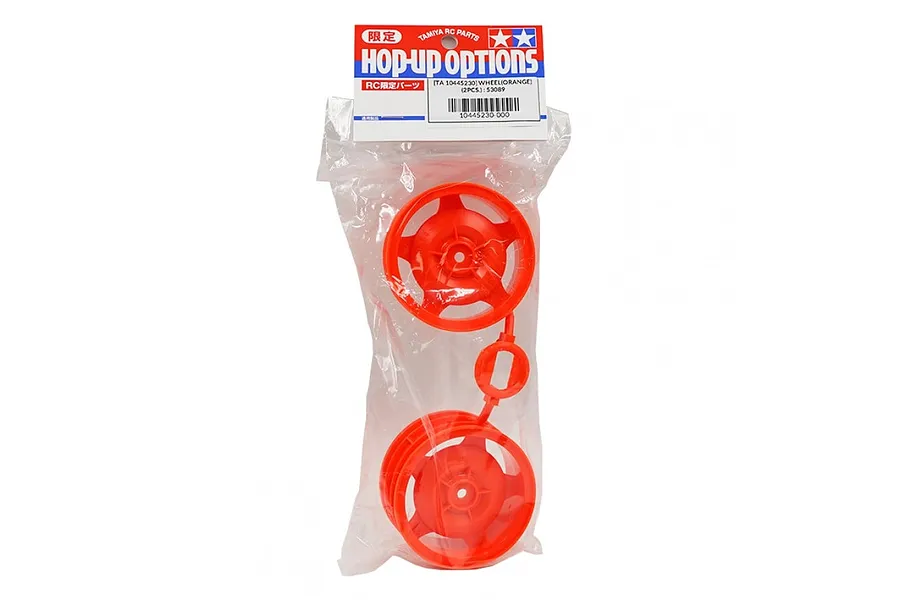 A pair of bright orange Tamiya RC buggy front wheels in their original plastic packaging with a header card.