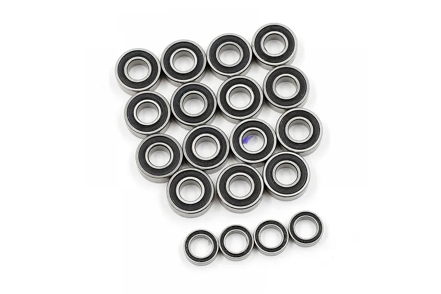 A collection of nineteen rubber-shielded ball bearings arranged on a white background.