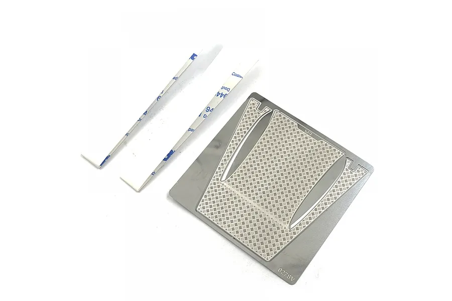 Yeah Racing stainless steel diamond plate engine cover set for RC cars, featuring a metal sheet with cutouts and two adhesive strips on a white background.