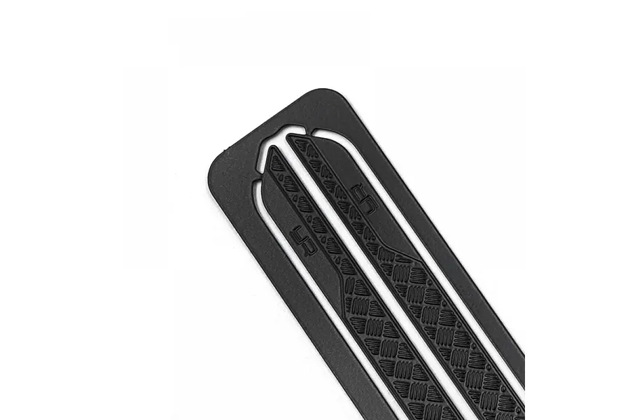 Close-up of a black metal rock rail with diamond plate texture and Yeah Racing logo branding.