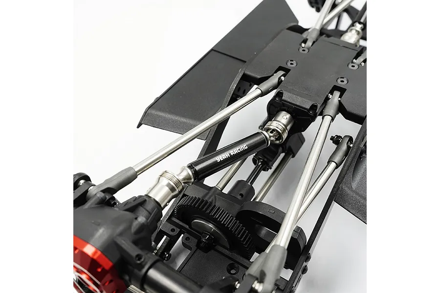 A black Yeah Racing aluminium driveshaft installed on an RC vehicle chassis, showing the drivetrain components.