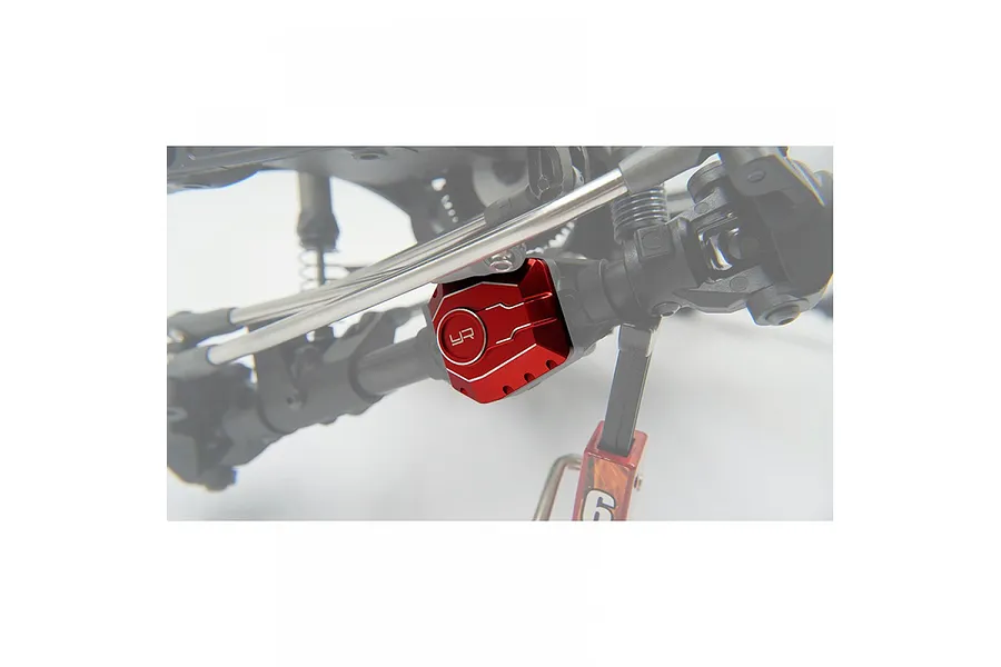 A red anodized aluminium differential cover with the Yeah Racing logo installed on an RC crawler axle.