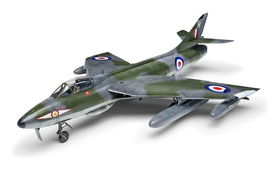A fully assembled and painted 1/48 scale model of a Hawker Hunter fighter jet, featuring a green and grey camouflage scheme with RAF roundels.