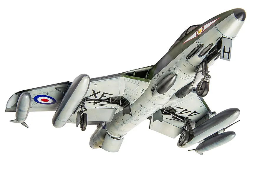 A completed 1/48 scale plastic model of a Hawker Hunter fighter jet, viewed from below with landing gear deployed.