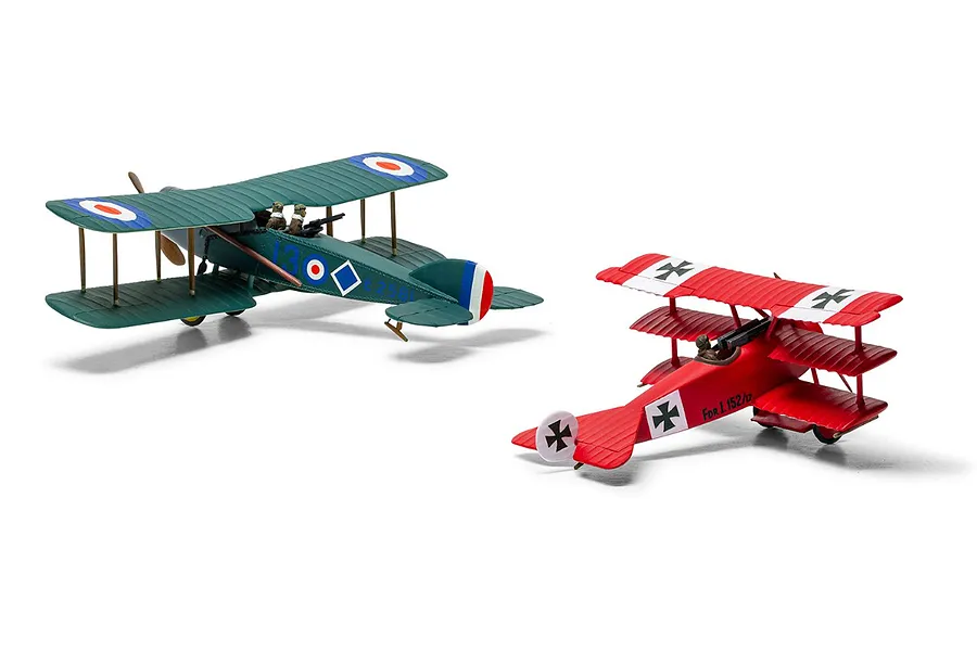 Two assembled and painted 1/72 scale model aircraft: a green Bristol F.2B and a red Fokker DR.1 triplane on a white background.