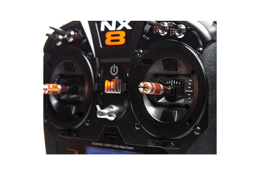 Close-up of the Spektrum NX8 transmitter face showing the control sticks, switches, and NX8 branding.