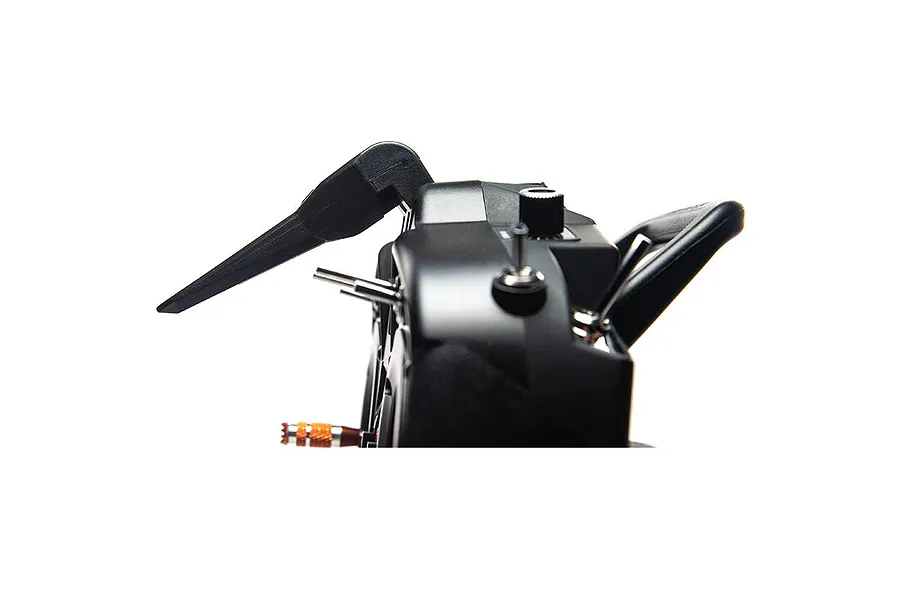 Close-up side view of a Spektrum RC transmitter showing the antenna, toggle switches, and a control knob.