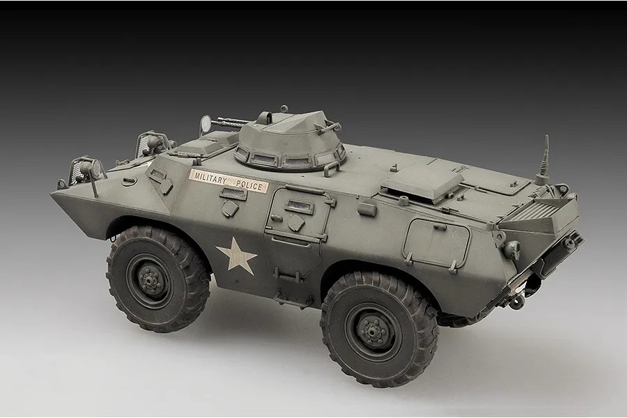 A completed 1/72 scale model of a US M706 Commando armoured car painted in olive drab with Military Police markings.