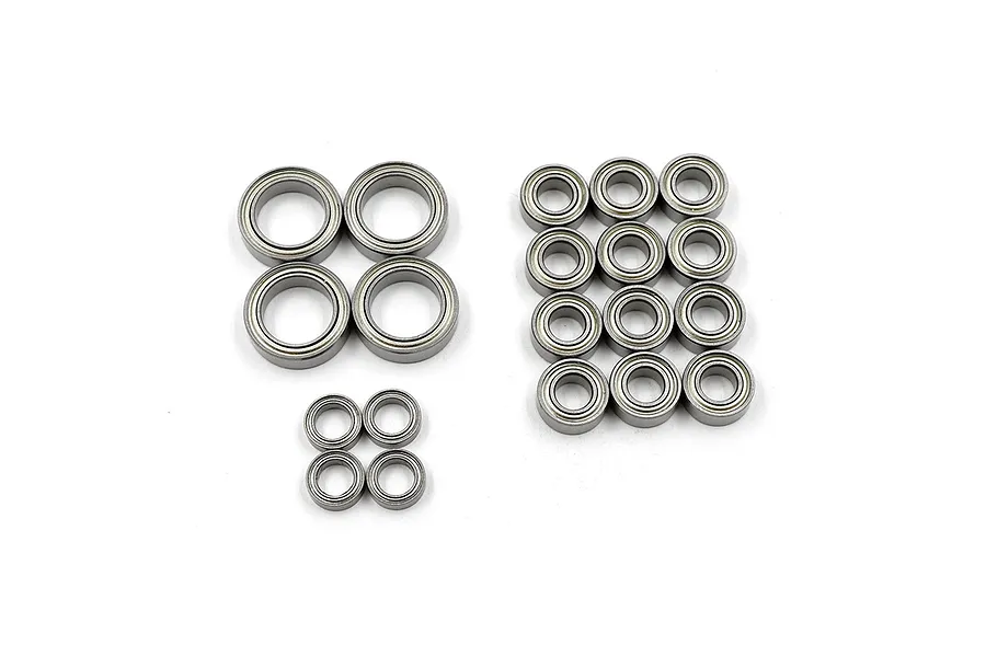 A collection of various sized metal shielded ball bearings arranged in groups on a white background.