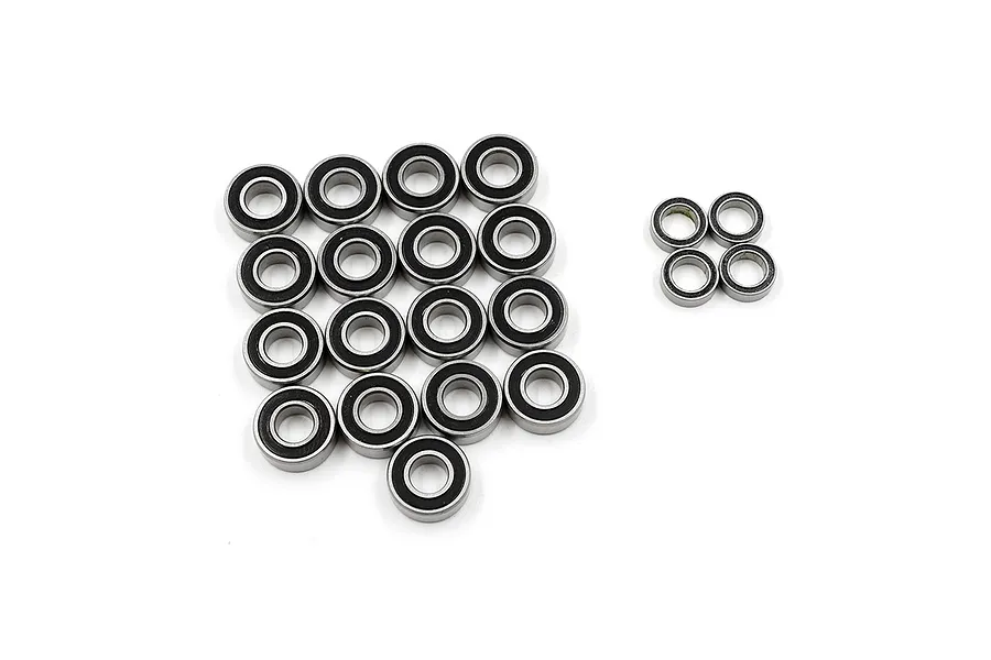 A collection of twenty RC ball bearings with black rubber seals arranged on a white background.