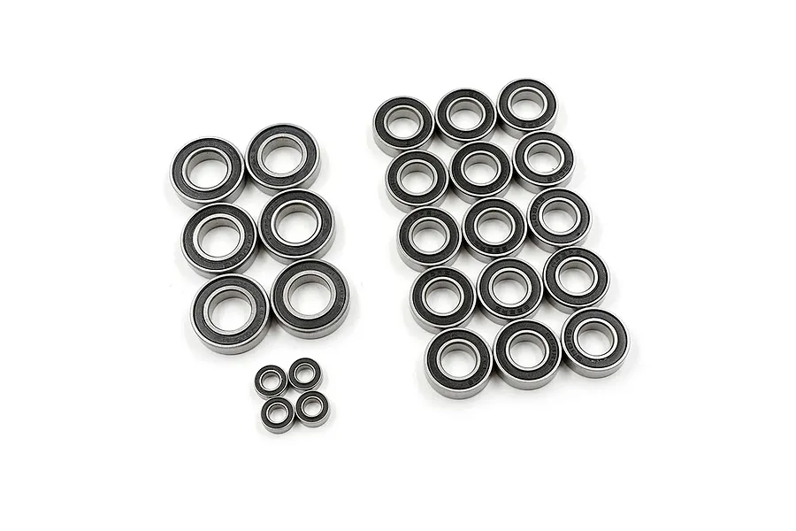 A collection of various sized rubber shielded ball bearings arranged on a white background.