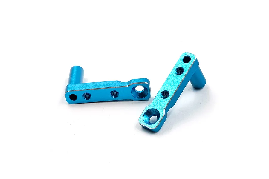 Two blue anodized aluminium servo mounts for RC cars, featuring threaded holes and a cylindrical post, isolated on a white background.