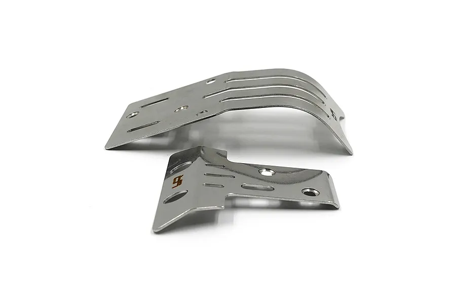 Two stainless steel skid plates for RC vehicles, one larger and one smaller, featuring mounting holes and slots, isolated on a white background.