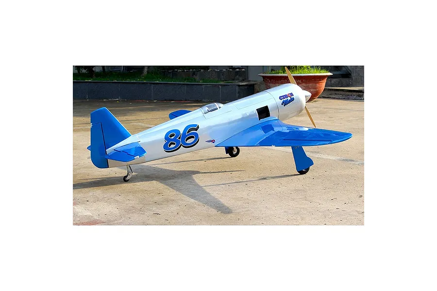A Seagull RC Reno Yak 11 model airplane in Czech Mate livery, featuring a silver fuselage with blue wings and tail, parked on a concrete surface.