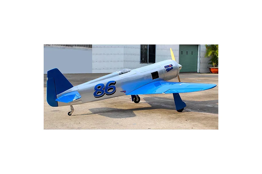 Seagull RC Reno Yak 11 warbird model plane in pearl blue and chrome livery with number 86 on the fuselage, parked on a concrete surface.