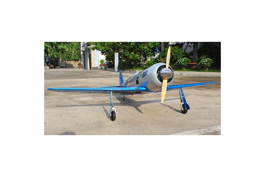 Front view of a Seagull RC Reno Yak 11 model plane in blue and chrome livery, parked on a concrete surface outdoors.