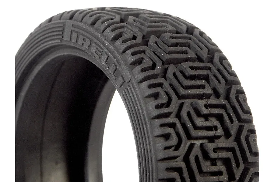 Close-up of a black rubber RC rally tyre with a distinct geometric tread pattern and Pirelli branding on the sidewall.