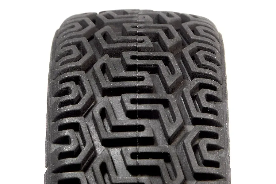 Close-up of the tread pattern on a black rubber RC rally tyre with a geometric, maze-like design.