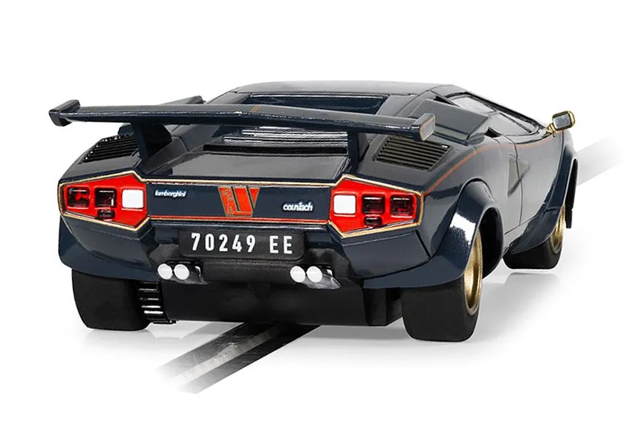 Rear view of a 1/32 scale Scalextric Lamborghini Countach slot car in dark blue with gold accents, featuring a rear wing and quad exhaust pipes.