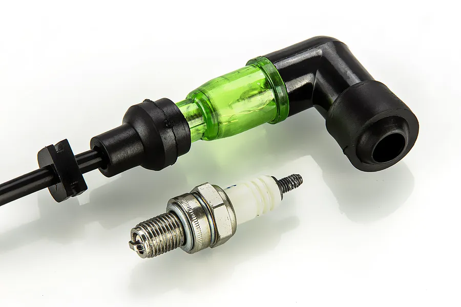 Rovan V2 Shining View ignition kit featuring a spark plug and a green translucent spark plug cap with a black rubber boot.