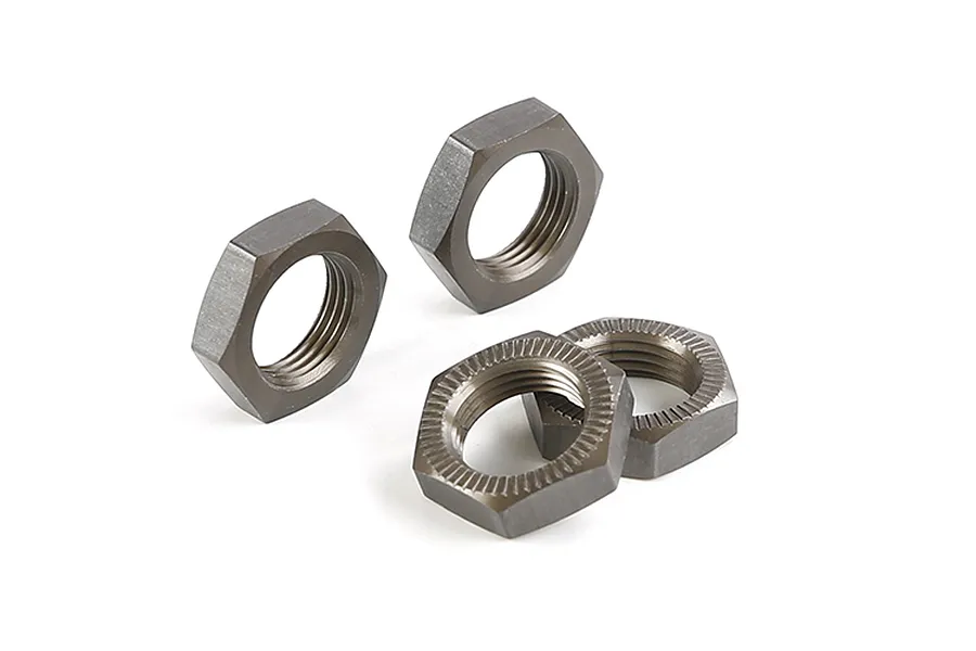 Four gunmetal grey aluminium hex wheel nuts for RC cars, arranged on a white background.