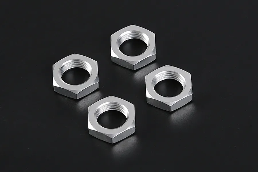 Four silver-coloured hexagonal wheel nuts arranged on a dark grey background.